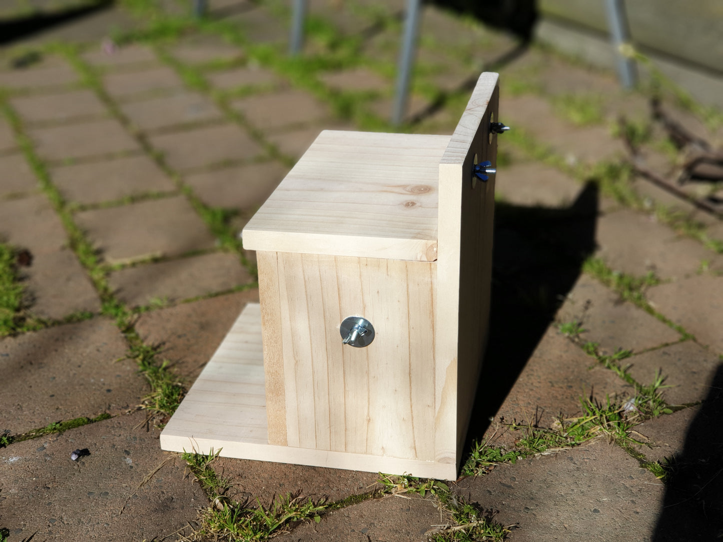 side view of kiln-dried pine cubby house. Has side bolt to attach to cage.